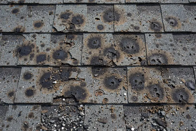 Hail-damaged asphalt shingles in Owasso Oklahoma showing bruising and granule loss