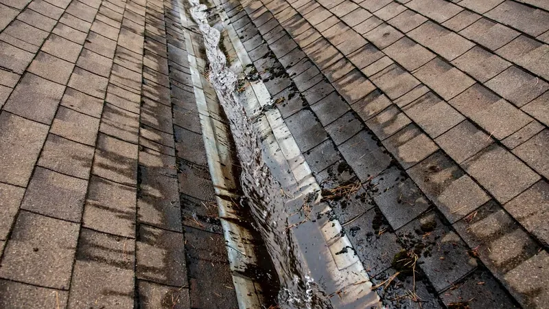 Water staining in a roof valley marking a leak entry point